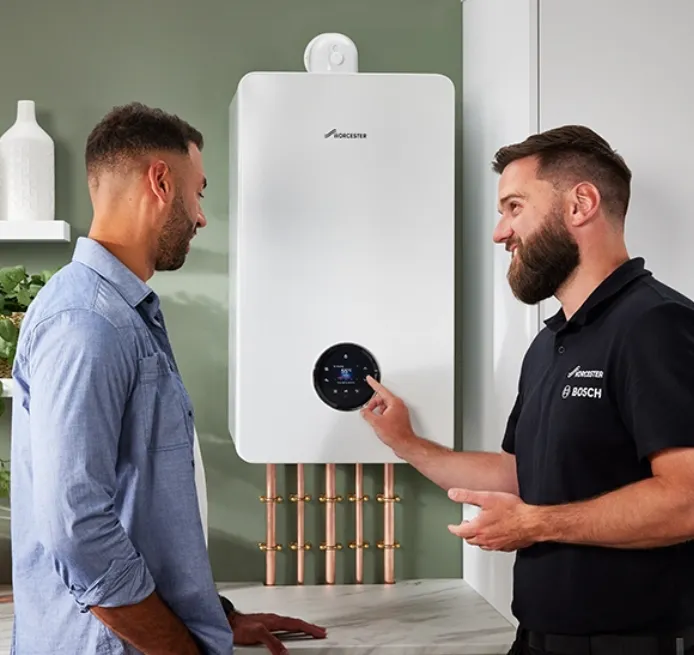 Heating engineer showing a customer a new Worcester Bosch combi boiler